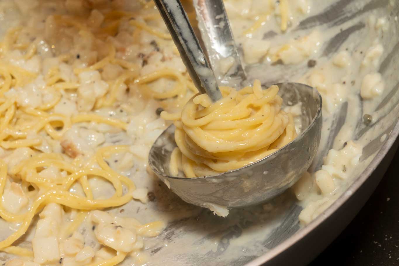 Se necessario, aggiungere un po’ di acqua di cottura della pasta. Quando il pecorino romano avrà iniziato a formare una crema, saltare la pasta per emulsionare la salsa. 
Impiattare in una ciotola capiente e concludere con un po’ di pecorino romano e qualche bacca di pepe Sichuan. 
